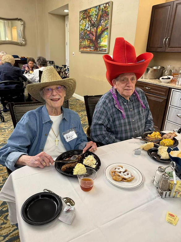 Parkway Place Senior Living residents smiling and enjoying a fun themed meal