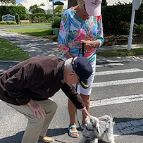 Veteran petting a dog
