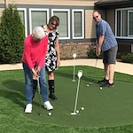 Harvester Place Senior Assisted Living Memory Care in Burr Ridge, IL residents playing mini golf, or putt putt