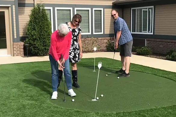 Harvester Place Senior Assisted Living Memory Care in Burr Ridge, IL residents playing mini golf, or putt putt
