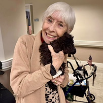 The Forum at The Crossing resident enjoys a visit from a dog