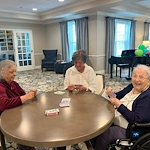 Charter Senior Living of Dedham in Dedham, MA, residents socializing and playing cards to keep their minds strong