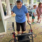 Wesley Manor Assisted Living Community offering assisted living and continuing care retirement community (CCRC) services in Louisville, KY, happy resident with a bowl of dessert