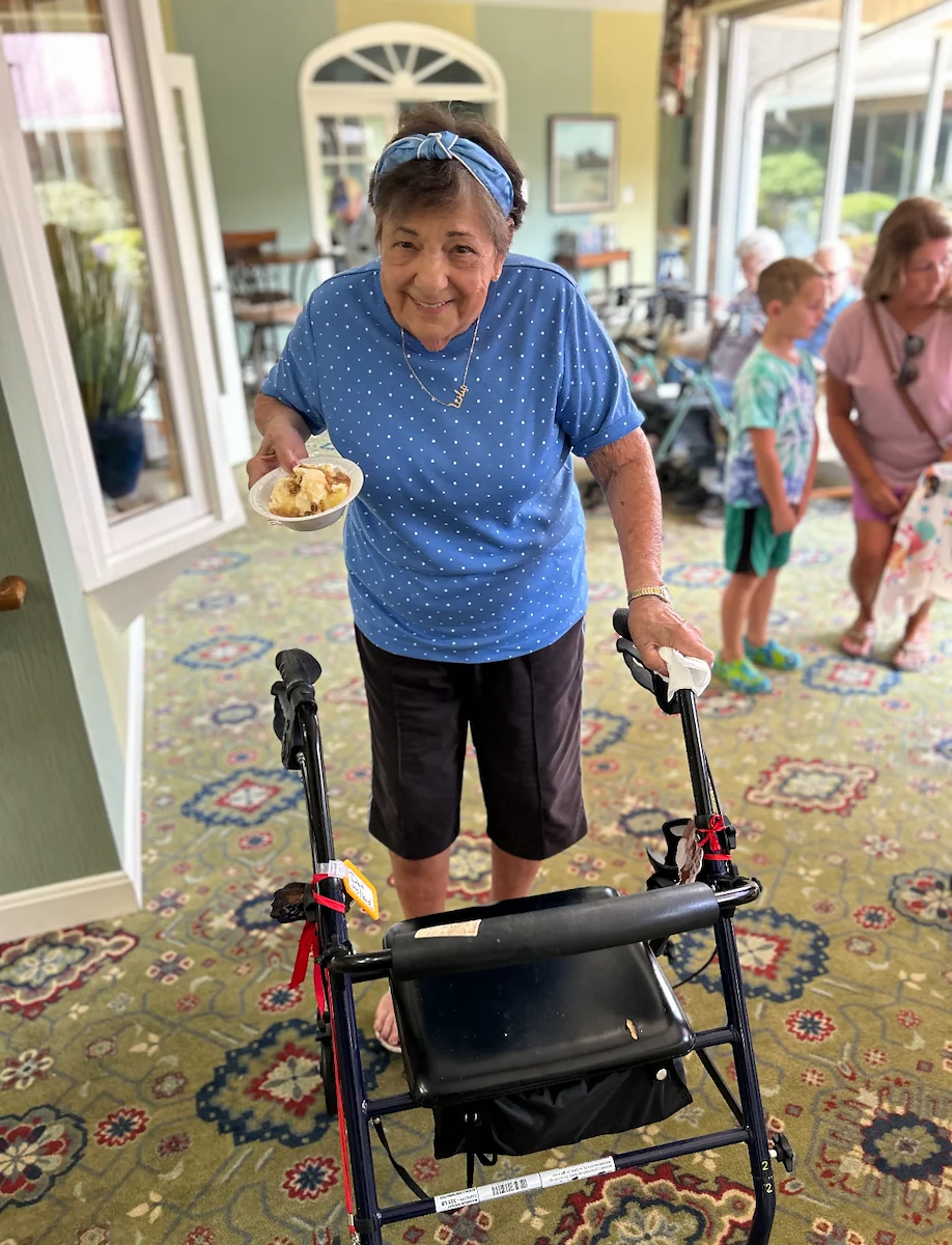 Wesley Manor Assisted Living Community offering assisted living and continuing care retirement community (CCRC) services in Louisville, KY, happy resident with a bowl of dessert