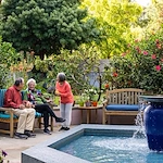 Piedmont Gardens Senior Living in Oakland, CA, residents enjoying the outdoor space and socializing