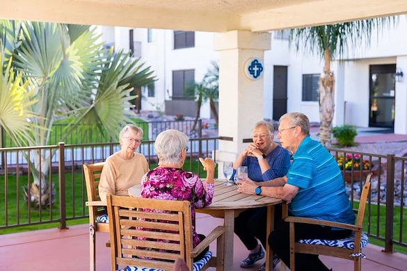 Friends enjoying company under the gazebo at Fellowship Square Mesa