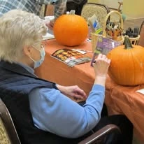 Ascension Living Via Christi Village Georgetown Senior Independent Living in Wichita, Kansas resident painting a pumpkin