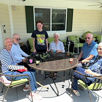 Faith Cottages Memory Care Basehor, KS, residents enjoy time outdoors and an engaging activity