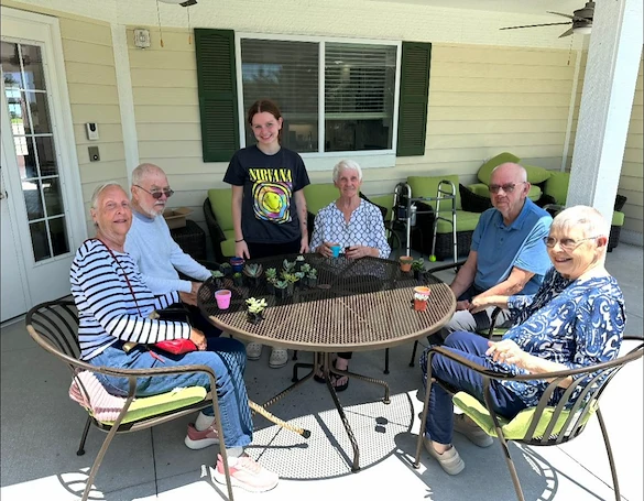 Faith Cottages Memory Care Basehor, KS, residents enjoy time outdoors and an engaging activity