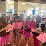 kids in the community delivering Valentine's Day cards to residents of Estrella Estates Gracious Retirement Living Hawthorn Senior Independent Living in Goodyear, Arizona