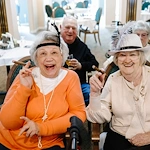 Chateau Pacific Lynnwood, WA, smiling residents enjoying a celebration for the community's 25 years