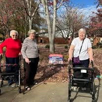 Jordan Oaks Gracious Retirement Living Hawthorn Senior Independent Living in Cary, North Carolina residents in front of a 'Happy Veteran's Day' sign