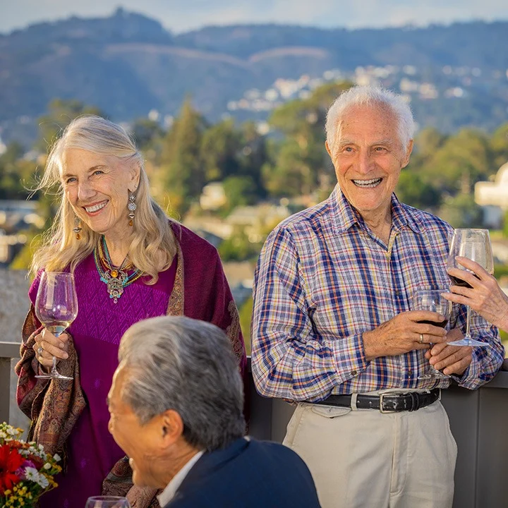 Piedmont Gardens Senior Living in Oakland, CA, smiling residents enjoying a glass of wine