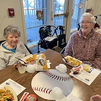 Waters of Eden Prairie residents enjoy a nacho bar to celebrate the start of baseball season