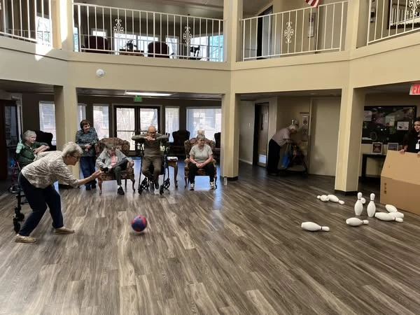 Whealdon Estates by Barclay House senior living community offering independent living in Baton Rouge, LA, residents stay active by participating in community bowling game