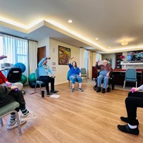 Residents of the Waters of Highland Park stay active by lifting some weights at the fitness center