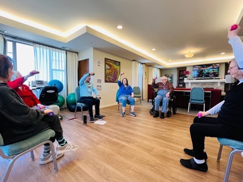 Residents of the Waters of Highland Park stay active by lifting some weights at the fitness center