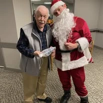 Ascension Living Resurrection Village Senior Living in Chicago, Illinois resident with Santa Claus
