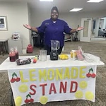 Shads Landing Gracious Retirement Living Hawthorn Senior Independent Living in Charlotte, North Carolina staff holding a lemonade stand