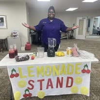 Shads Landing Gracious Retirement Living Hawthorn Senior Independent Living in Charlotte, North Carolina staff holding a lemonade stand