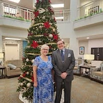 Hudson Estates Gracious Retirement Living Hawthorn Senior Independent Living in Lansdale, Pennsylvania resident couple in front of a Christmas tree