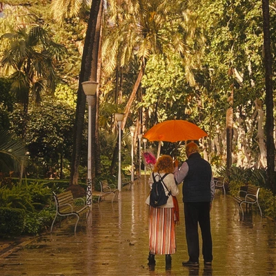 Retirement Reimagined: What Comes After Work? | senior couple walking with umbrella