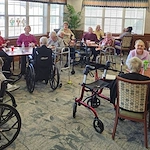 Allisonville Meadows Assisted Living offering assisted living, memory care, and respite care in Fishers, IN, residents gathered in the dining room socializing