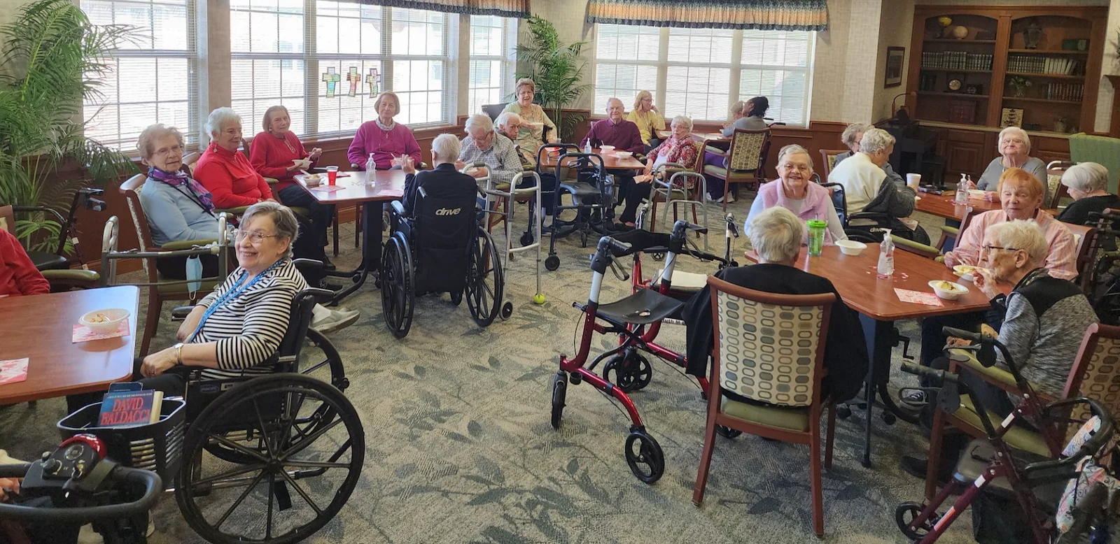 Allisonville Meadows Assisted Living offering assisted living, memory care, and respite care in Fishers, IN, residents gathered in the dining room socializing