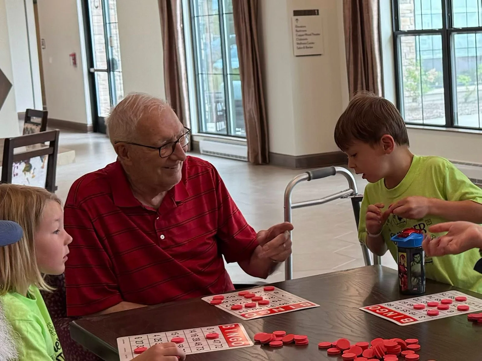 CopperWood at Prairie Trail senior living community offering assisted living and memory care in Ankeny, IA, resident enjoys visitors and a fun activity