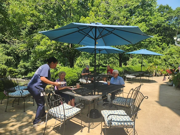 Charter Senior Living of Fredericksburg, Virginia, residents socializing outside in a comfortable environment