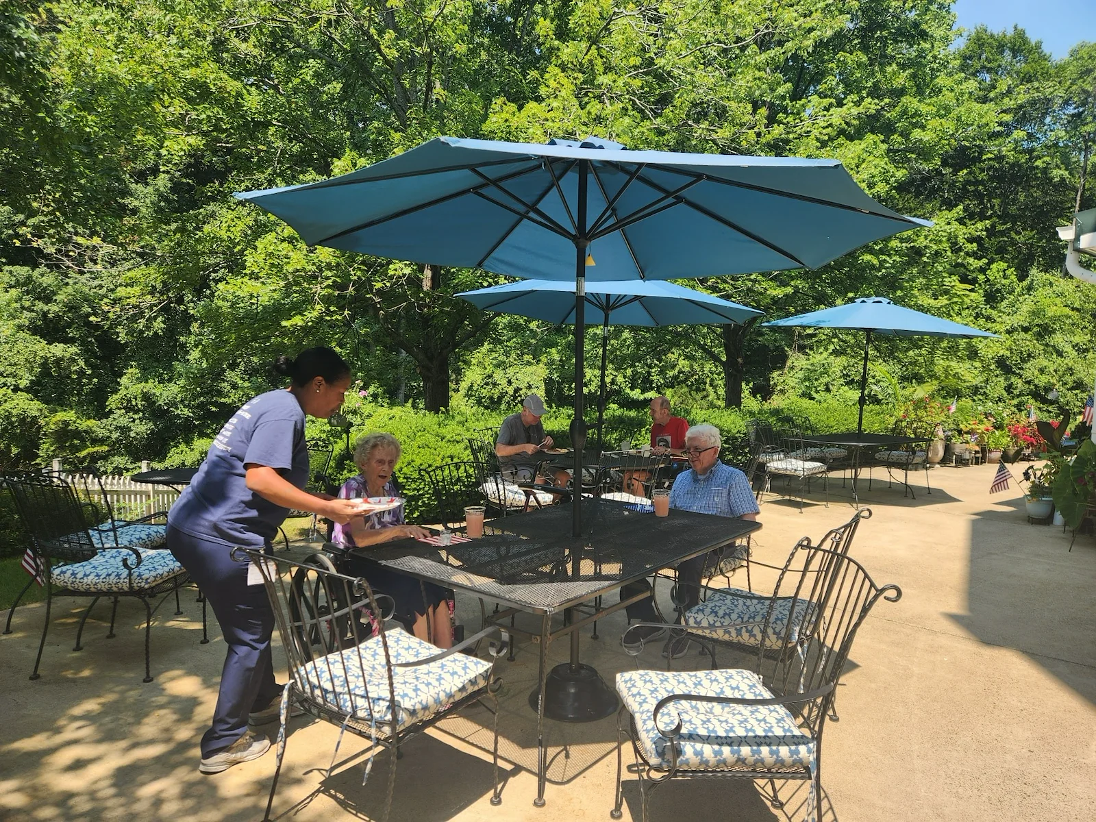Charter Senior Living of Fredericksburg, Virginia, residents socializing outside in a comfortable environment