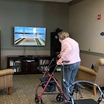 Covenant Living at The Holmstad in Batavia, IL, resident staying active with a fun Wii game