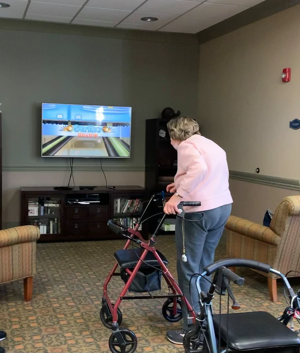 Covenant Living at The Holmstad in Batavia, IL, resident staying active with a fun Wii game