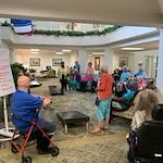 The Lodge at Wake Forest Gracious Retirement Living Hawthorn Senior Independent Living in Wake Forest, North Carolina residents playing a game in the front entrance