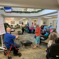 The Lodge at Wake Forest Gracious Retirement Living Hawthorn Senior Independent Living in Wake Forest, North Carolina residents playing a game in the front entrance