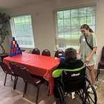 Shads Landing Gracious Retirement Living Hawthorn Senior Independent Living in Charlotte, North Carolina resident in a wheelchair playing a game