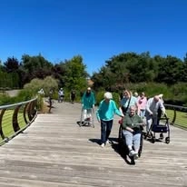 The Arbor at Avamere Court Assisted Senior Living in Keizer, Oregon residents crossing a bridge outside