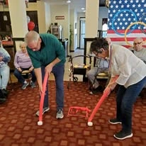 Magnolia Heights Gracious Retirement Living Hawthorn Senior Independent Living in Franklin, Massachusetts residents playing a competitive game