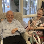 American House Stone senior living community offering independent living and respite care in Rochester Hills, MI, residents smiling and enjoying each others' company