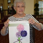 The Oaks Gracious Retirement Living Hawthorn Senior Independent Living in Georgetown, Texas resident holding a craft