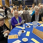 American House Stone senior living community offering independent living and respite care in Rochester Hills, MI, residents socializing as they dine together