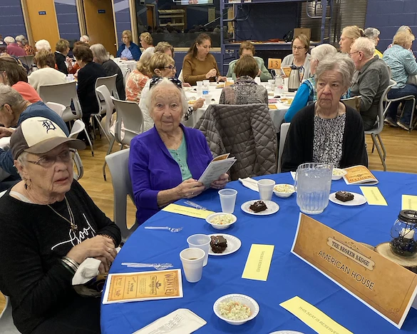 American House Stone senior living community offering independent living and respite care in Rochester Hills, MI, residents socializing as they dine together