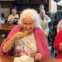 seniors eating treat at Serenades at Longwood