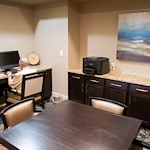 Franklin Park at Sonterra resident on the computer in the business office