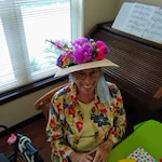The Carriage House Gracious Retirement Living Hawthorn Senior Independent Living in Oxford, Florida resident wearing a flower hat