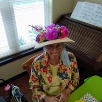 The Carriage House Gracious Retirement Living Hawthorn Senior Independent Living in Oxford, Florida resident wearing a flower hat