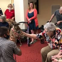 Meadowlark Estates Gracious Retirement Living Hawthorn Senior Independent Living in Lawrence, Kansas residents petting an animal