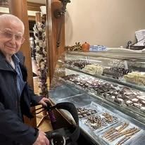 Camellia Gardens Gracious Retirement Living Hawthorn Senior Independent Living in Maynard, Massachusetts resident in front of a dessert case