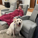 Credo Senior Living - Wichita, KS, resident enjoys a visit from a dog