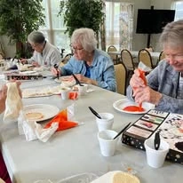 Orchard Heights Gracious Retirement Living Hawthorn Senior Independent Living in Clermont, Florida residents decorating fall cookies